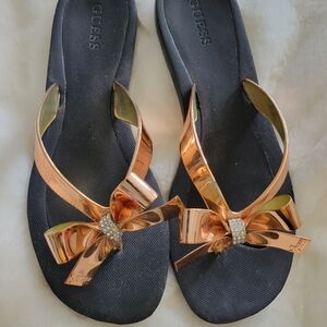 GUESS Women's Black Flip Flops with Rose Gold Bow Accent